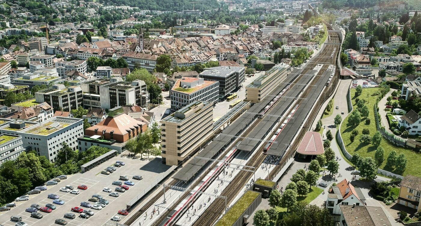 Visualisierung Luftaufnahme des Bahnhofs Liestal. Blick auf vier Gleisspuren mit der Stadt im Hintergrund