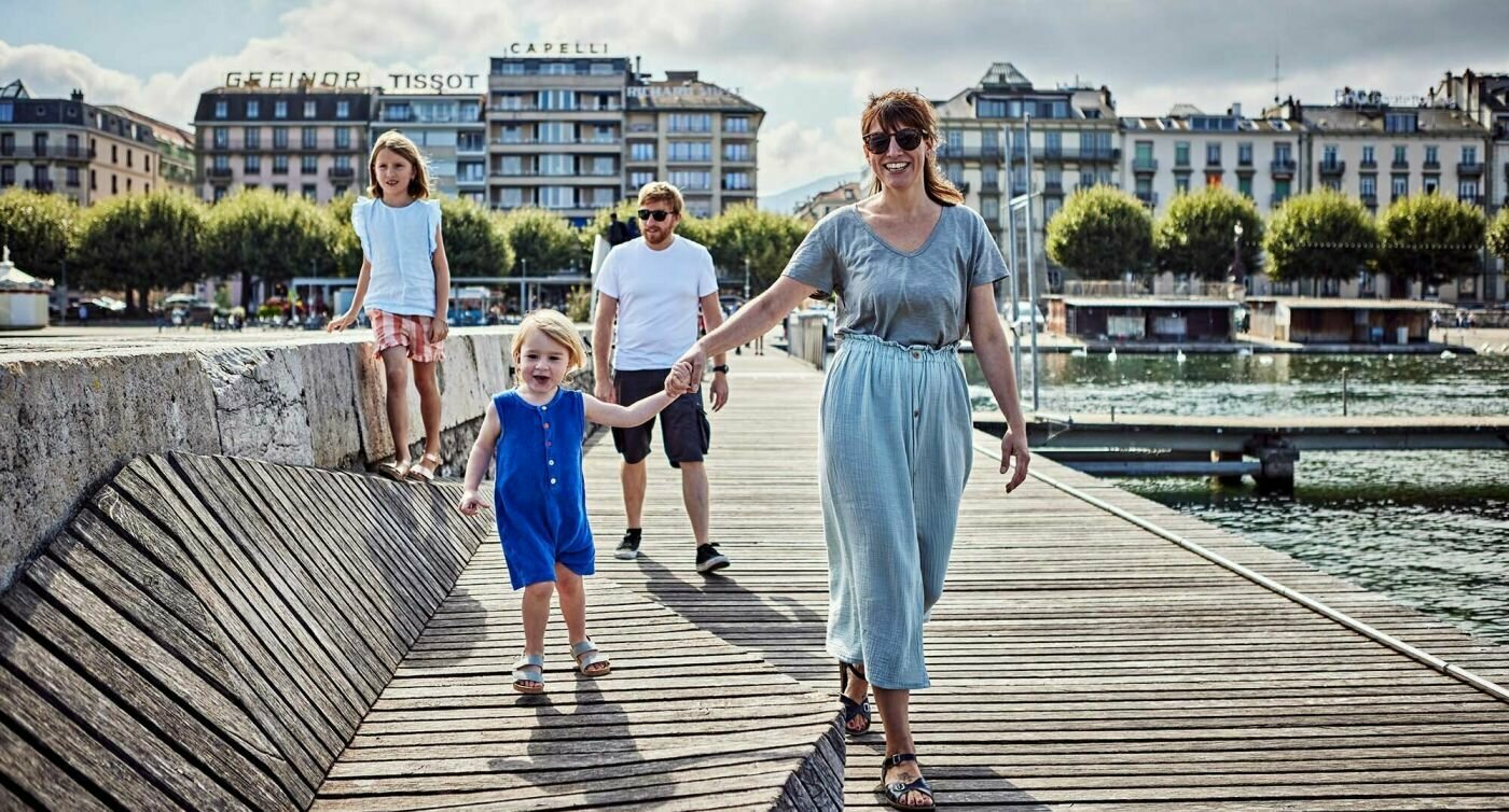 Emilie Servettaz se promenant sur un ponton avec sa fille, suivie de quelques pas par son compagnon et sa seconde fille.